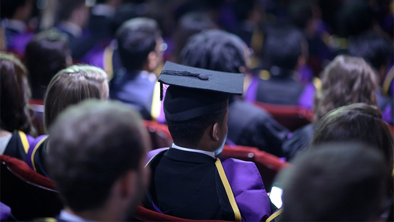 Back of graduates at ceremony